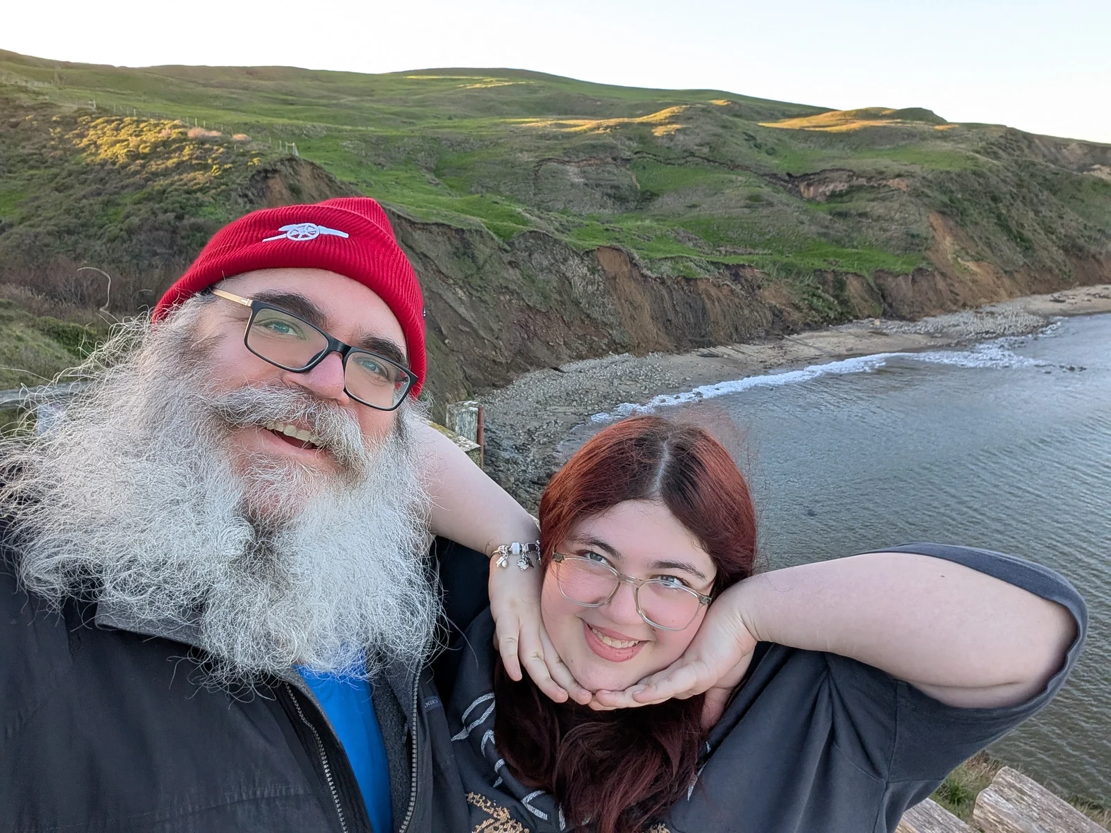Nico and Dad smiling beside the coast